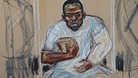 Michael Adebolajo sits in the dock holding a copy of the Koran.