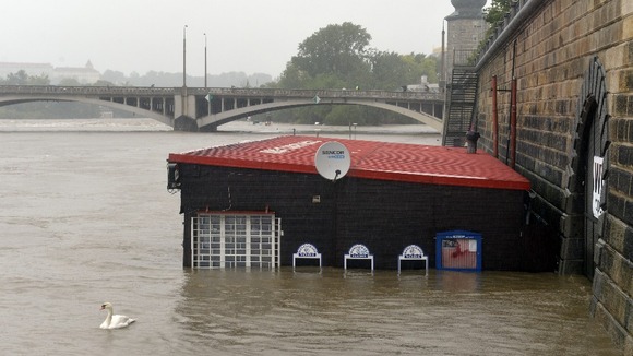 A restaurant at flooded riverside is seen in centre of Prague.