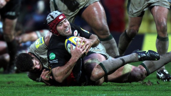 Saracens Schalk Brits is held by Northampton's Phil Dowson