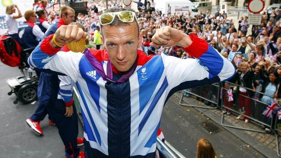 Richard Whitehead takes part in the parade through London, celebrating Britain's Olympic and Paralympic sporting heroes.