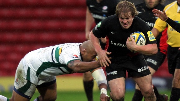 Saracens' Rhys Gill is tackled by Northampton's Soane Tonga'uiha (left)