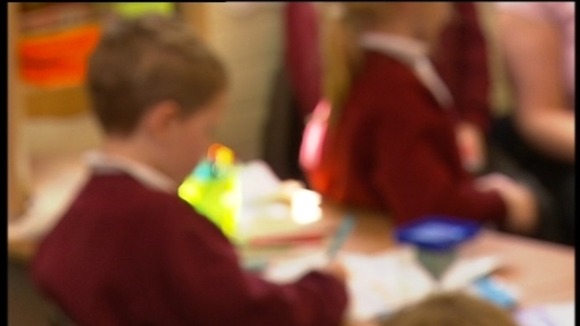 blurred shot of children in classroom