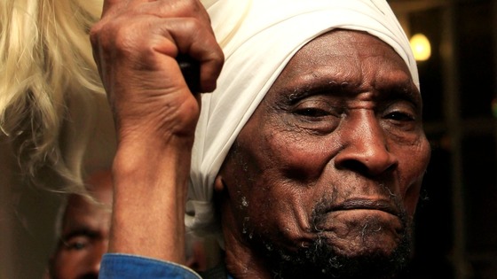 Daniel Macharia, a member of the Mau Mau War Veterans Association, salutes during a news conference today. 