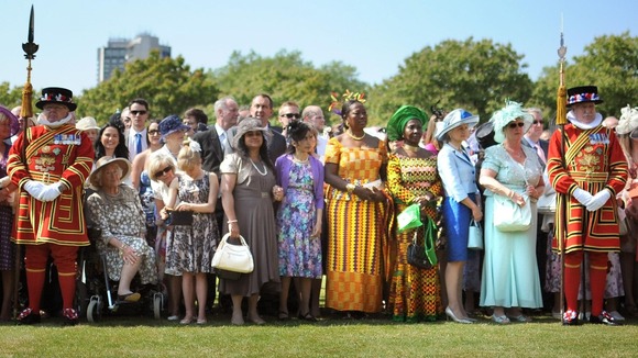 Guests wait for Queen Elizabeth II at a Garden Party at Buckingham Palace, London