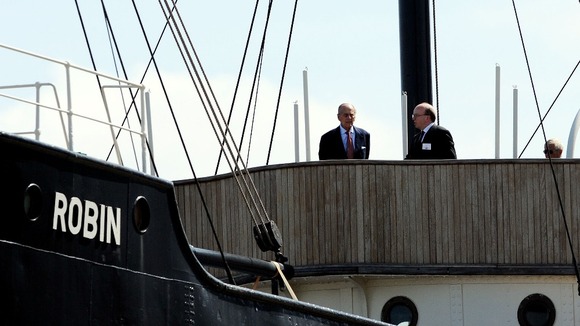 Duke of Edinburgh (left), stands aboard the SS Robin