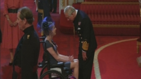 Sophie Christiansen receives an OBE from Prince Charles at Buckingham Palace.