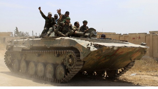 Soldiers loyal to the Syrian regime in the village of Debaa near Qusair