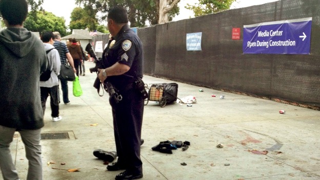 A policeman stands guard over the scene where a man believed to be the suspect in a shooting incident at Santa Monica College