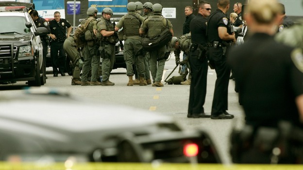 Police officers gather during a search at Santa Monica College