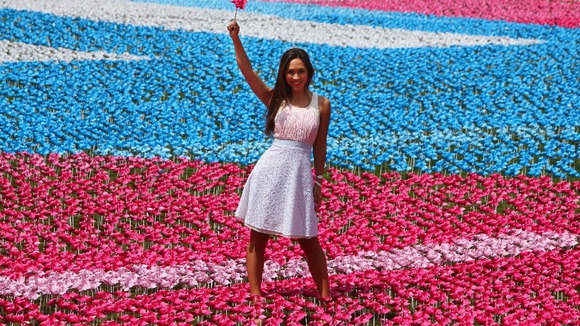 Myleene Klass stands with one of 250,000 flowers with eight petals