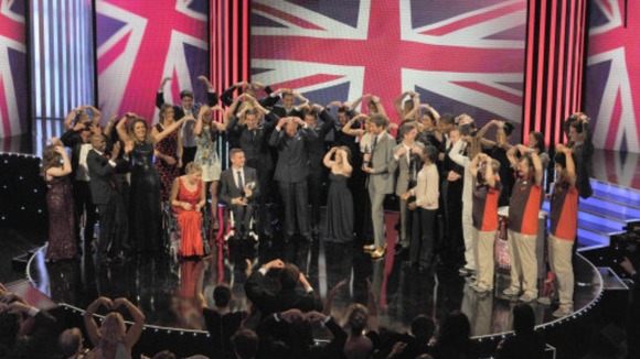 The Prince of Wales with members of Team GB and Paralympic BG doing the 'Mobot' at the Daily Mirror Pride of Britain Awards 2012 in London.