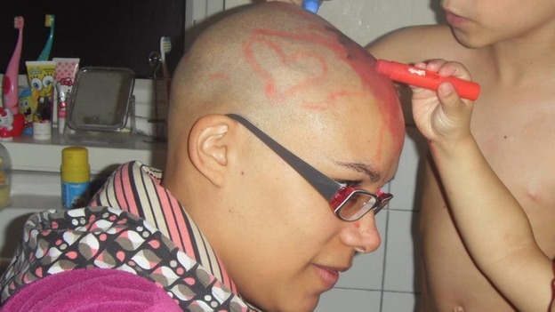 Laura Richards lets her children draw pictures on her head with crayons