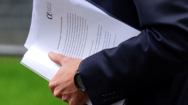 Davide Serra carrying papers outside Downing Street.