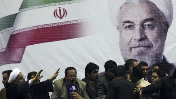 Iranian presidential candidate Hassan Rouhani (L) waves to supporters in the central Iranian city of Shiraz