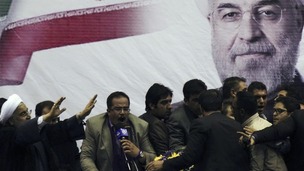 Iranian presidential candidate Hassan Rouhani (L) waves to supporters in the central Iranian city of Shiraz