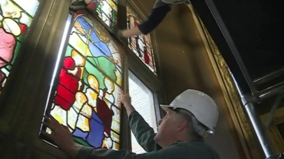 Experts removing stained glass window