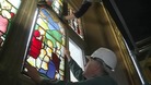 Experts removing stained glass window
