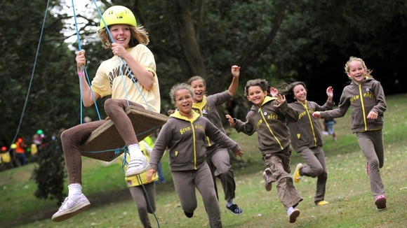 Brownies enjoy the zip-wire activity at the Girl Guiding UK's Centenery celebration