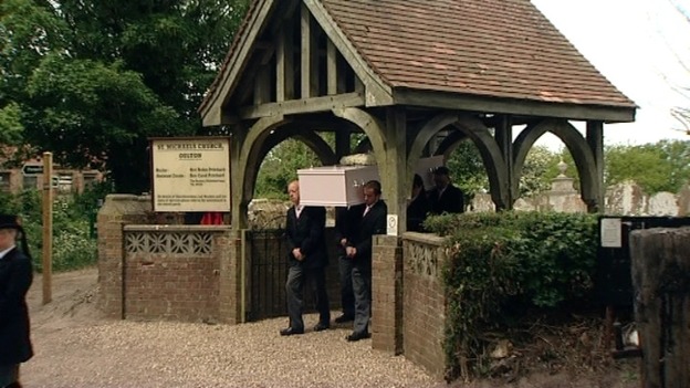 The coffin is carried from the church