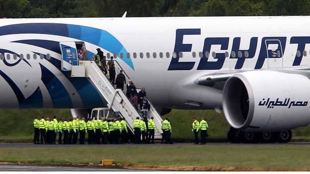 Passengers leave the Egyptair aircraft flying from Cairo to New York after it was diverted to Prestwick Airport