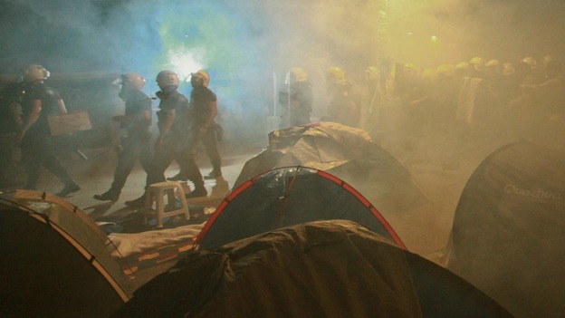 Police in riot gear walk through a cloud of tear gas in Istanbul's Gezi Park.