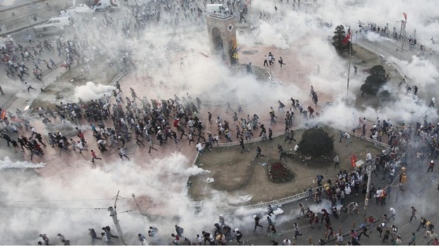 Protesters flee as tear gas fills the square in protests earlier this week.