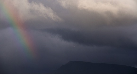 Rainbow against dark skies