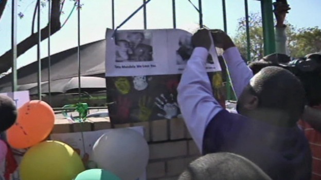One family member removes a mural to take inside to Nelson Mandela.