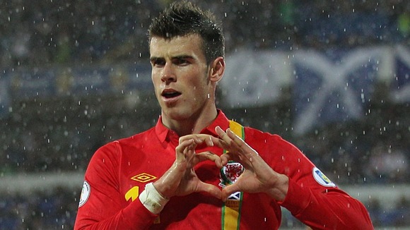 Gareth Bale celebrates scoring a goal for Wales with the heart-shaped hand gesture.