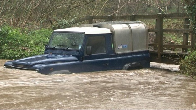 A Landrover is surrounded by water after heavy rainfall