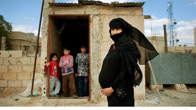 Muna, a Syrian refugee living in Mafraq, Jordan. She fled her home in Hamidiyeh in Homs province with her children in the summer of 2012.