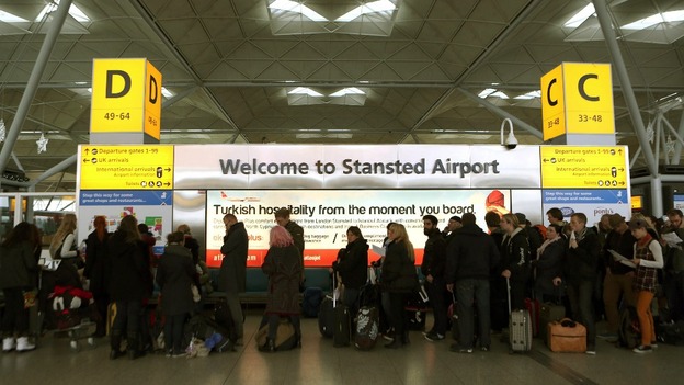 Passengers queue at Stansted Airport