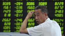 Board showing stock information filled with green-coloured figures, which indicate falling prices