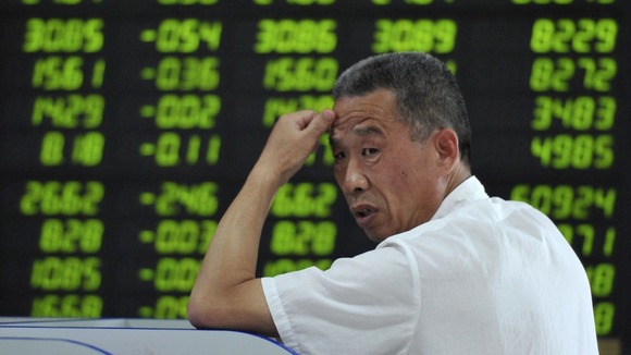 Board showing stock information filled with green-coloured figures, which indicate falling prices