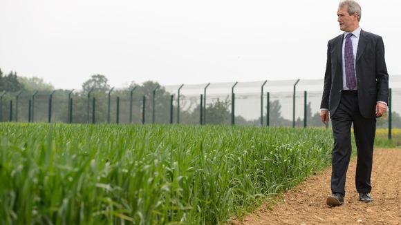 Environment secretary Owen Paterson views a genetically modified crop trial during a visit to Rothamsted Research.