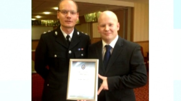 PC Adam Koch with his award, with fellow police officer.