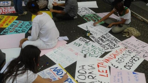 Protesters paint banners for their demonstration
