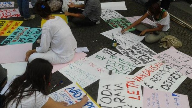 Protesters paint banners for their demonstration