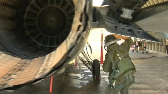 An Israeli pilot checks the engine of an F1 fighter jet.