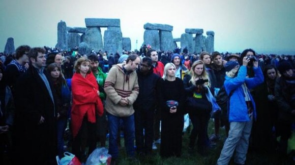 Revellers attempts to see the sun rise at Stonehenge