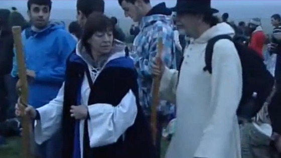 A man and woman in suitable attire at Stonehenge