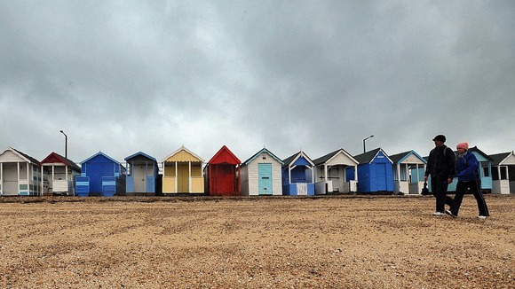 Wrapping up against the weather on the beach at Southend.