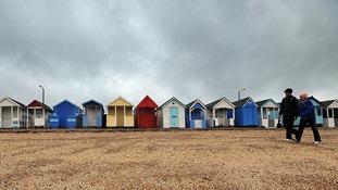 Wrapping up against the weather on the beach at Southend.