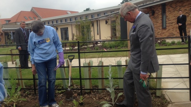 Prince Charles tours the gardens of the Marie Curie Hospice in Solihull, which he opened today.