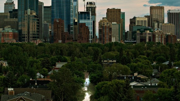 A man walks down a flooded street in the city of Calgary