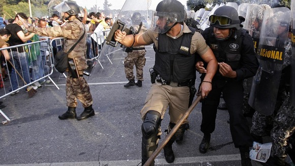 Riot police try to control the demonstrators in Brazil.