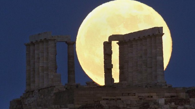 Supermoon rises over the temple of Poseidon, the ancient Greek god of the seas, in Cape Sounion
