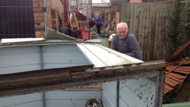 Resident Andrew Sheriff surveys damage
