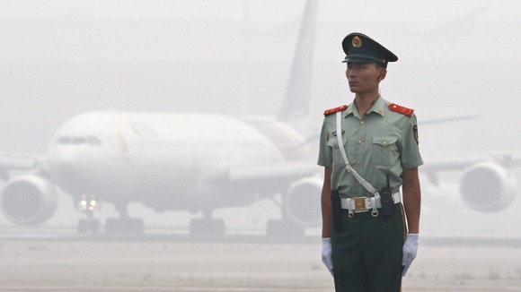 A Chinese paramilitary policeman on the tarmac at Beijing airport