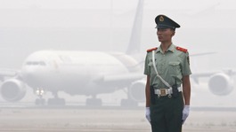 A Chinese paramilitary policeman on the tarmac at Beijing airport